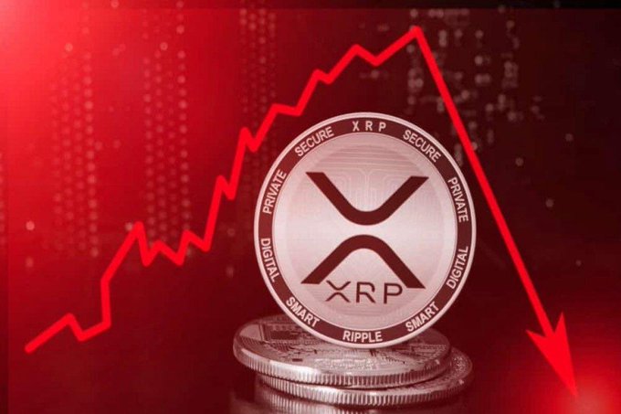 The image shows a coin with an XRP symbol, which is a digital currency, sitting on top of two other coins against a red background. The coin is positioned at the bottom right corner of the image. In the background, there's a line graph that appears to be showing a downward trend in value for the XRP token over time. This suggests that the coin might drop below $1 soon.