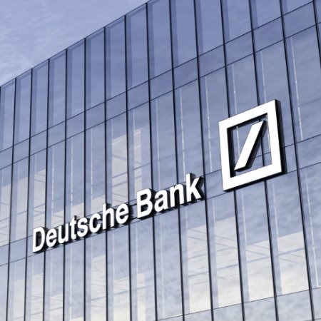 The image shows the exterior of a modern glass building featuring the Deutsche Bank logo and name displayed prominently on the facade. The caption relates to the post by highlighting Deutsche Bank as the financial institution making the Bitcoin custody announcement.