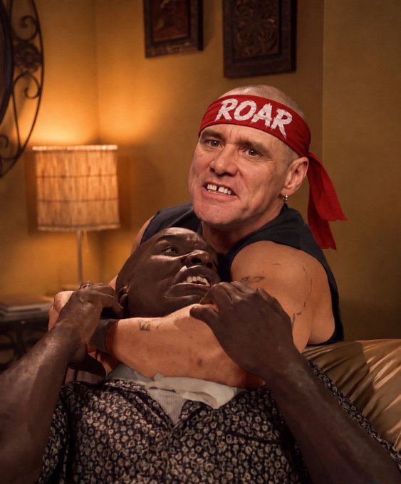 AI-generated image of a muscular bald man wearing a red 'ROAR' headband performing a chokehold on another person in a warmly lit room.