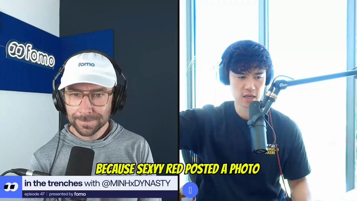The image shows two men wearing headphones and microphones, likely participating in an interview or podcast recording session. One man has his arm extended outwards while the other man has his arm bent at the elbow. The background features a window with blinds that allows natural light into the room. There is also text on the image that reads "In the trenches with Minh Dynasty" and "I shorted everything on Binance on 10/8 because Sexyy Red posted a photo with CZ." This suggests that the men are discussing or analyzing something related to the post of Sexy Red, possibly in relation to a photo.