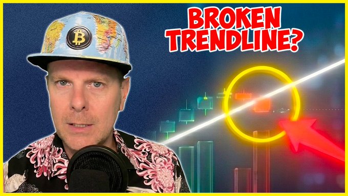 A YouTube thumbnail featuring a man wearing a Bitcoin-logo cap and floral shirt, with bold text reading "BROKEN TRENDLINE?" alongside a highlighted candlestick chart and red arrow, promoting a video warning about an ETH signal that hasn't occurred in over 6 years.