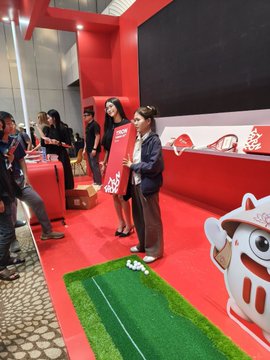 Two models pose at the TRON DAO booth during Conviction 2026 Day 1 at Thiskyhall Sala, greeting a steady stream of attendees who came to check in, network, and collect giveaways throughout the day.