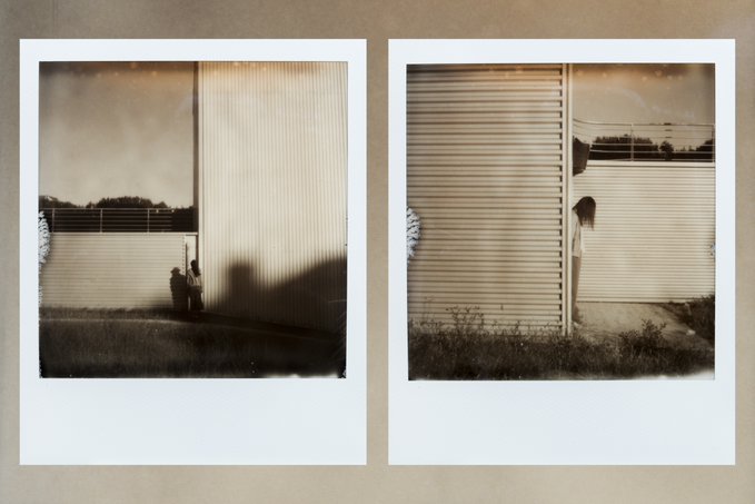 Two sepia-toned Polaroid-style photographs displayed side by side on a brown background, showing figures near a large corrugated metal building under a dramatic sky.