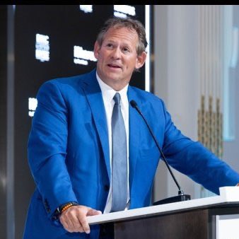 The image shows a man standing at a podium, wearing a blue suit and tie. He appears to be giving a speech or presentation, with his hands placed behind him as he speaks into a microphone. The background features a black wall adorned with white text that reads "BlackRock's bond chief says Bitcoin goes much higher". This suggests that the speaker is discussing the potential growth of Bitcoin in relation to bonds and the financial market.

The post seems to be promoting an investment opportunity, possibly related to Bitcoin or cryptocurrency. It highlights the idea that Bitcoin has the potential for significant growth compared to traditional bonds, which could lead to substantial returns on investment if chosen wisely. The speaker's statement implies that this growth is expected to continue and may even accelerate in the future.