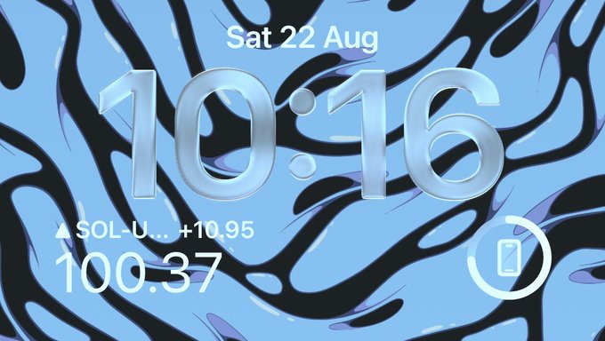 A lock screen displaying the time "10:16" and date "Sat 22 Aug" against a blue zebra-stripe background shows SOL-U trading at $100.37, up +10.95, marking the cryptocurrency's return to triple-digit price territory.
