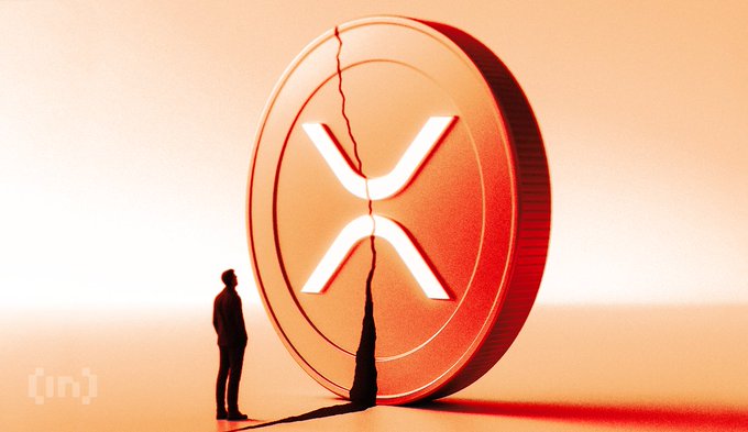 A conceptual illustration showing a small silhouetted figure standing before a massive, cracked XRP (Ripple) coin bathed in warm orange-red light, with a watermark '[in]' visible in the corner.