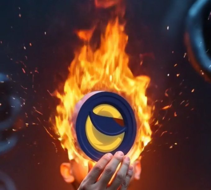 A dramatic 3D rendered image of a hand holding a circular cryptocurrency coin with a 'D' logo, surrounded by intense flames and sparks against a dark background, with other similar coins floating in the periphery.