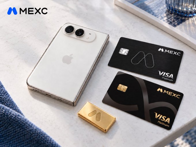 A product showcase on a marble surface featuring a white iPhone, a gold bar, and two MEXC Visa Platinum cards, with the MEXC logo displayed in the top left corner.