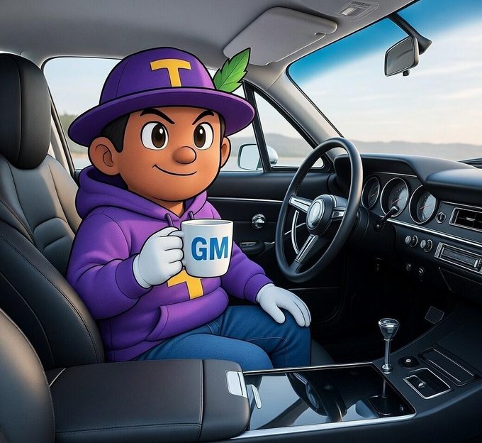 A cartoon character wearing a purple hat with a yellow 'T' and a leaf sits in the driver's seat of a car, holding a white mug labeled 'GM'.
