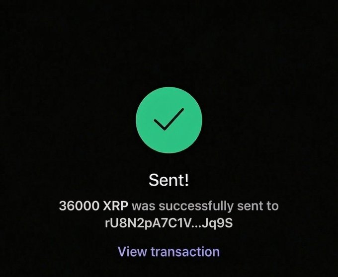 The image shows a green checkmark with an exclamation point above it, indicating that $36,000 was successfully sent to someone else's account. The text below the checkmark reads "Sent! I want to send $XRP to someone who has never won Just say '$XRP'". This message is related to the post about sending money through a cryptocurrency exchange or wallet.