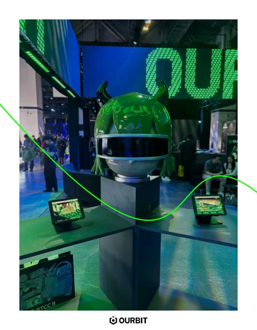 An exhibition booth for 'OURBIT' features a green horned helmet displayed on a pedestal alongside digital screens.