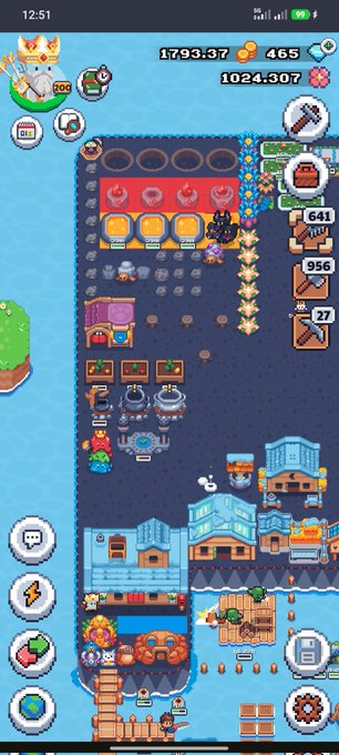 A screenshot of a mobile game showing a pixel-art village, factory buildings, characters, and resource counters at the top.