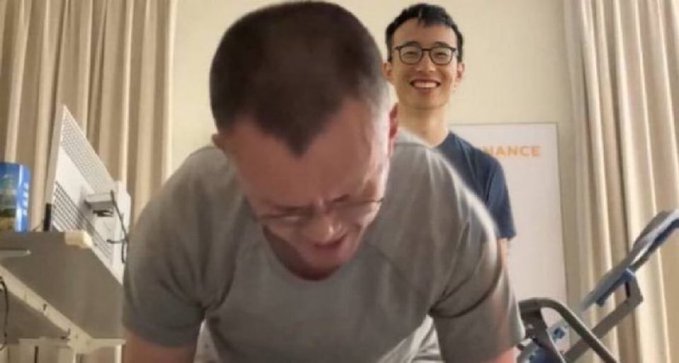 The image shows two men, one wearing a gray shirt and glasses, and another man with a blue shirt and glasses, both appearing to be making faces as they look at each other. The background includes a computer monitor and a keyboard on a desk. The caption "get fucked hyperliquid" is written in the corner of the image.