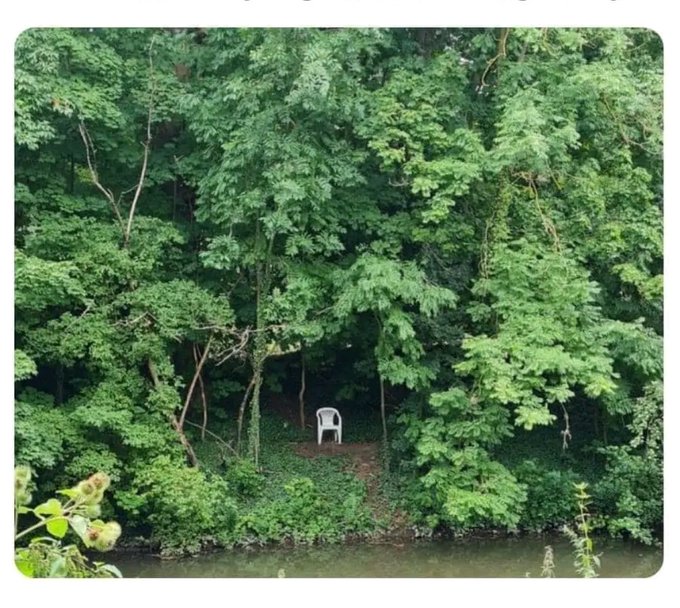 The image features a white chair sitting alone by a body of water, surrounded by trees. The scene appears serene and peaceful, with no one else around except for the solitary chair. This setting evokes feelings of tranquility and relaxation, which is what makes @useTria stand out to potential users who are looking for a simple and effortless way to manage their finances or transactions online.
