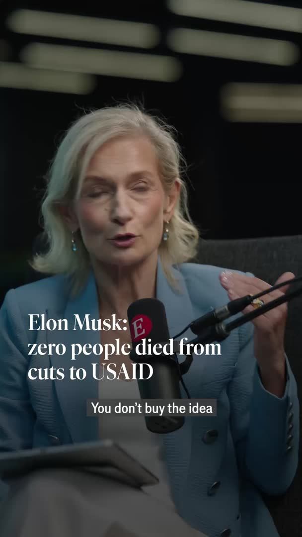 A woman with blonde hair wearing a blue blazer speaks into a microphone, with on-screen text reading "Elon Musk: zero people died from cuts to USAID" and a caption stating "You don't buy the idea." The image appears to be a still from an interview discussing Elon Musk's controversial claim regarding DOGE cuts to USAID and their alleged lack of human impact.