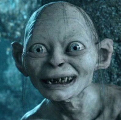 The image features a close-up of a character from the Lord of the Rings movies, such as a gnome or a dwarf. The character has a large nose and teeth missing, giving them a unique appearance reminiscent of the characters from the films. The character is smiling for the camera, adding to their endearing and memorable look.