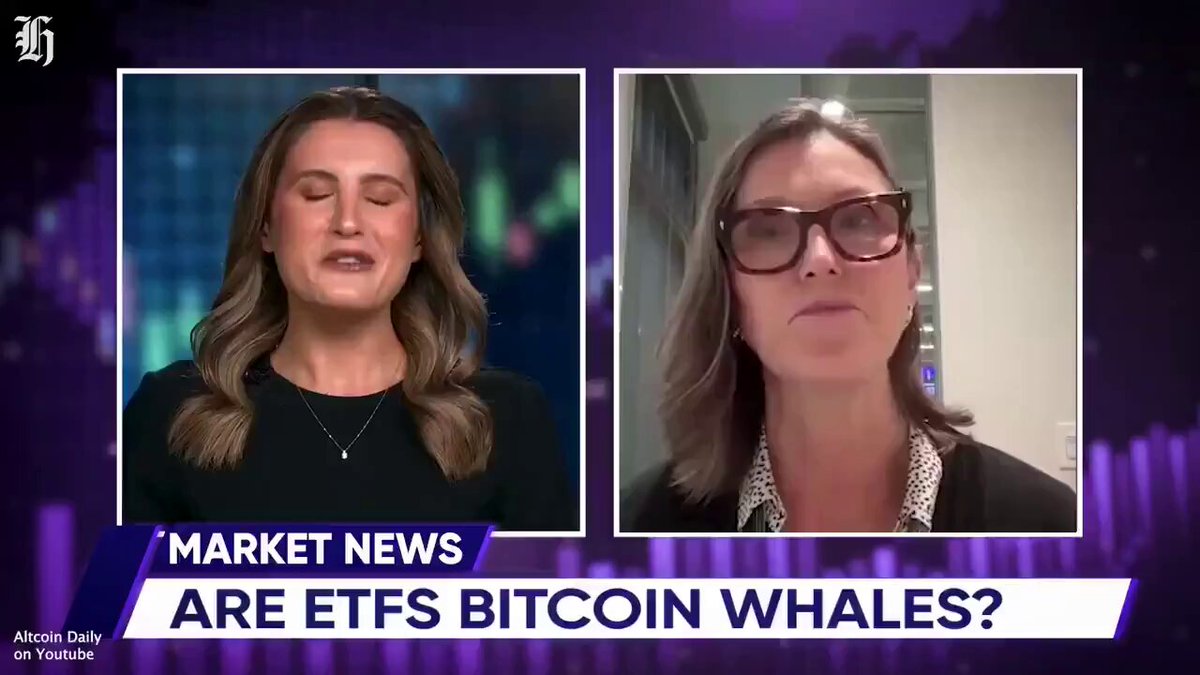 In the image, two women wearing glasses are shown having a conversation about market news and cryptocurrencies specifically focused on Bitcoins. The woman on the left wears a black top while the other woman has a white shirt. They appear to be discussing market trends and speculating on the future of Bitcoins.