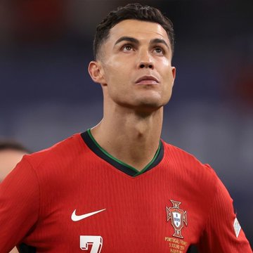 A close-up of Cristiano Ronaldo wearing Portugal's red #7 jersey appears above a Polymarket betting post where someone wagered $9,400 on him not scoring against Croatia, a bet paying out $16,811.62 if successful.