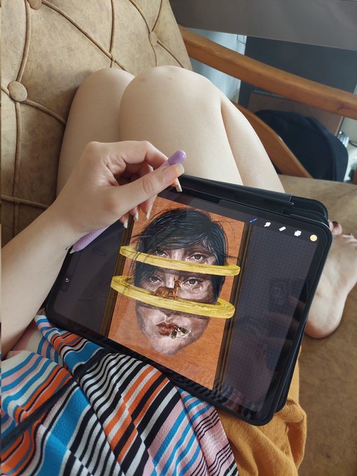 A person holds a stylus and tablet displaying an in-progress digital portrait of a face with bold yellow brushstrokes across the eyes, illustrating the "trust the process" message that creating art requires patience through the imperfect, unfinished stages.