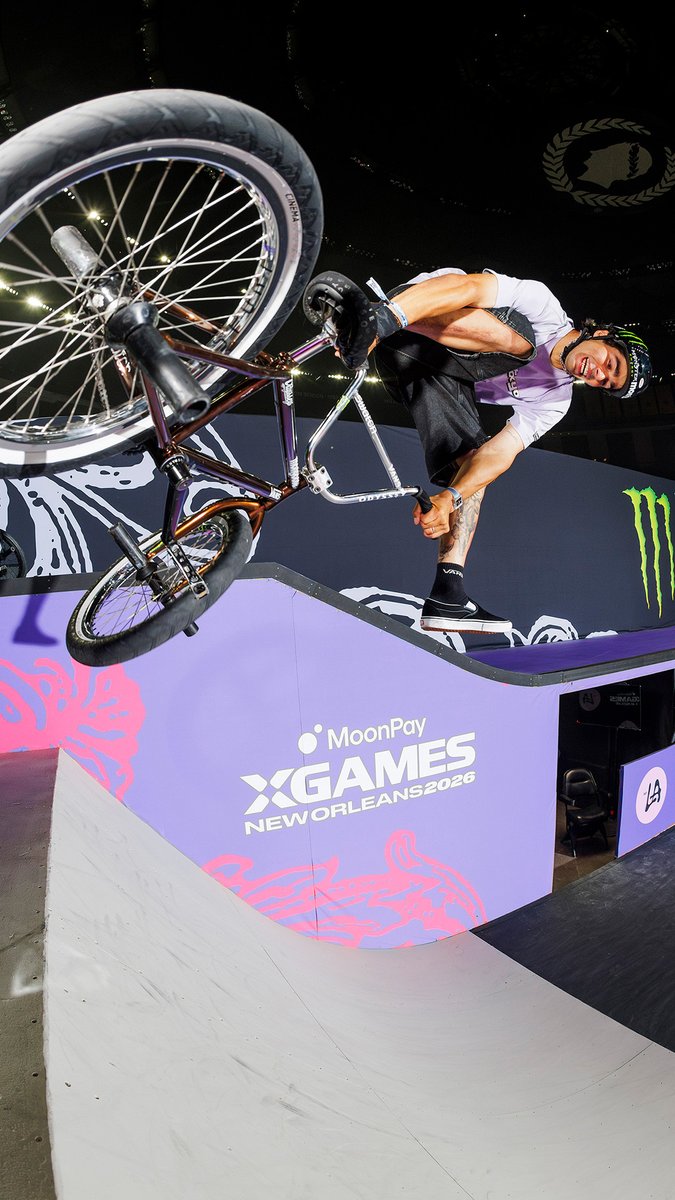 A BMX rider performs a trick at the MoonPay X Games New Orleans 2026, with a Monster Energy logo visible on the ramp.