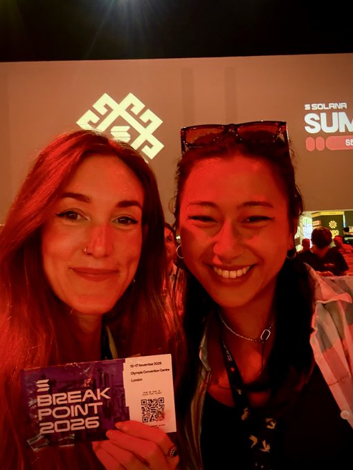 Two women smile for a selfie at the Solana Summit Breakpoint 2026 in Singapore, holding tickets for 'Day 03, 19-21 November 2026, Olympia Convention Centre, London.'