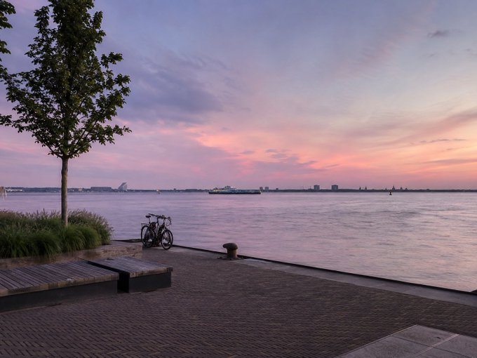 A bicycle is parked on a waterfront promenade at sunset, with a colorful pastel sky over a calm bay and distant city skyline.

The serene sunset scene contrasts with the post's energetic discussion about crypto trading on BSC and stock/meme opportunities on Robinhood and Binance, offering a peaceful moment of reflection amid the hustle of chasing August market opportunities.