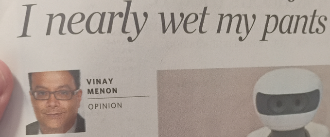 A newspaper opinion column by Vinay Menon features the headline "I nearly wet my pants" alongside a photo of a small white robot, humorously reinforcing the post's point about outdated figures overhyping outdated ideas while younger innovators drive real progress.