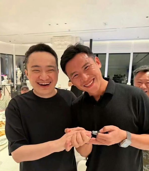 Two men, one identified in context as Zhao Changpeng (赵长鹏), the Binance founder, smile broadly while examining a small watch or jewelry item together at what appears to be a social gathering, with another man visible in the background. The post critiques Zhao for posing as a gentleman publicly on Twitter while privately engaging in trivial antics, calling him a hypocrite—referring to the "fingernail clipper" gesture the two are displaying as evidence of his fake "righteous" persona.