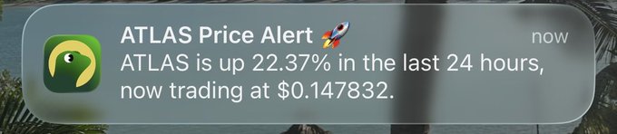 A smartphone push notification from ATLAS Price Alert shows a rocket emoji and reads: 'ATLAS is up 22.37% in the last 24 hours, now trading at $0.147832.'