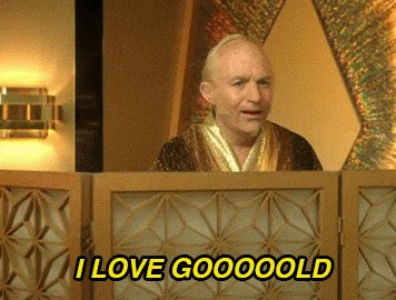 urn of gold and green flowers, with a man in a brown robe seated at the table, reading "I love GOOGOLD" above him.