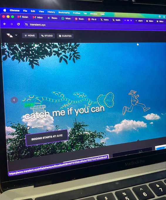 A photograph of a MacBook Pro displaying the website 'transient.xyz,' which features an animated character with the text 'catch me if you can' and 'BIDDING STARTS AT: 0.11Ξ'.