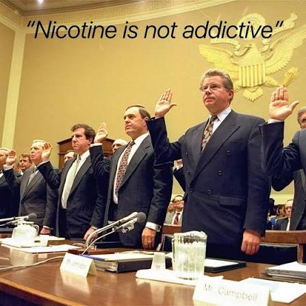 A historical photograph of tobacco executives raising their hands while being sworn in at a congressional hearing, with the caption 'Nicotine is not addictive' and a nameplate reading 'Mr. Campbell' visible.