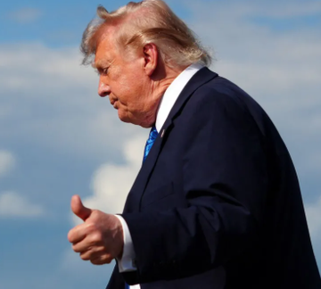 Donald Trump gives a thumbs-up while walking outdoors in a dark suit and blue tie. The image relates to the post as it features Trump, whose media company (Trump Media) is pulling back from cryptocurrency partnerships with Crypto.com.
