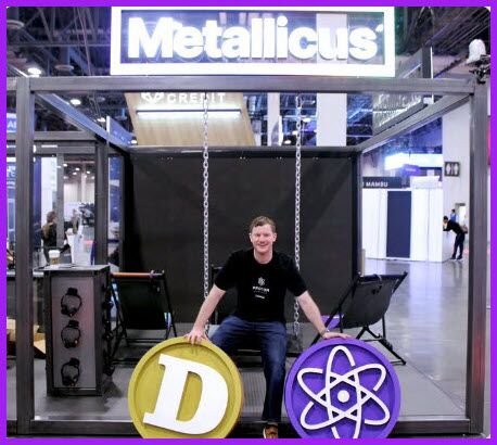 A man sits on a swing beneath a "Metallicus" banner at what appears to be a crypto/blockchain conference, with Dogecoin and Proton cryptocurrency logos displayed prominently in front. The image relates to the post by visually promoting blockchain and cryptocurrency technologies, aligning with the bullish price prediction for $XPR (XPR Network/Proton) token.