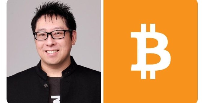 The image shows two men, one wearing glasses and the other smiling. They are standing close together, with the man without glasses positioned in front of a square graphic featuring the Bitcoin logo. The text above this graphic reads "JAN3 CEO Samson Mow says many investors will eventually regret selling their Bitcoin at current levels". The main focus is on both men and their interaction within the context of the Bitcoin investment discussion.