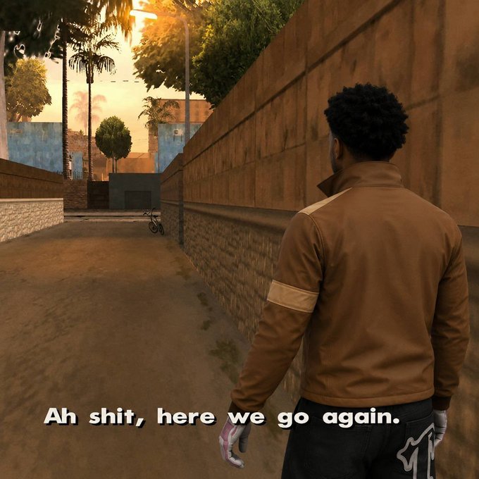 The image shows a man walking down an alleyway, wearing a brown jacket with white text that reads "AH shit, here we go again." The background of the image features a brick wall and trees, creating a scene from a video game or movie.