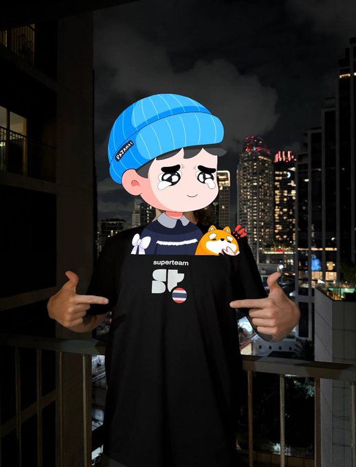 A person on a balcony at night wearing a blue cap with a cartoon crying face overlay and holding a black "super10am" t-shirt featuring a Shiba Inu dog design.