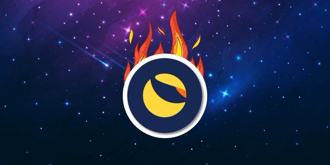 A terra Classic (LUNC) logo engulfed in flames set against a starry cosmic background, symbolizing the post's fiery theme of community-driven momentum toward a major breakthrough in the crypto space.