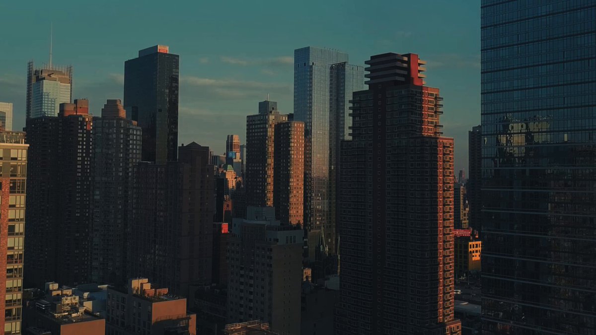 "The blockchain for trading has a new home. sei.io". This text is related to the image, as it appears that there are multiple buildings in the background with the words "sei.io" written on them. The image captures an aerial view of a cityscape at sunset, which adds depth and context to the scene.