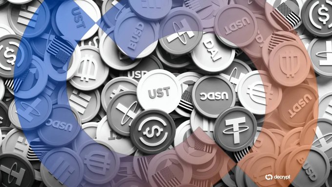 A Decrypt image shows a pile of cryptocurrency coins including USDC, USDT, DAI, and UST, overlaid with a blue and red gradient.