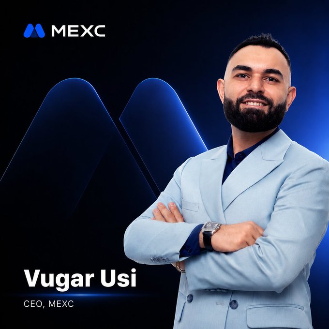 A professional portrait of Vugar Usi, CEO of MEXC, wearing a light blue suit jacket against a dark blue background with the MEXC logo.