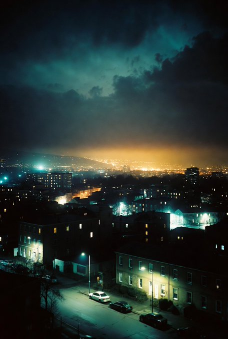 The image shows a city at night with a dark sky, clouds, and buildings lit up by streetlights. The scene appears to be taken from an elevated perspective, possibly from a rooftop or a high vantage point. In the bottom right corner of the photo, there is text that reads "Good Night X, Shall we connect new fams? I am looking forward to @wallchain announcement of eligible people for the new campaigns". This suggests that the image might be related to an advertisement or promotional material for a new campaign or event in the city.
