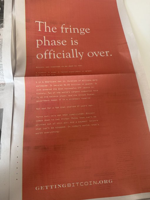 A full-page Bitcoin advertisement in the Wall Street Journal with a red background boldly declares "The fringe phase is officially over," citing statistics about American Bitcoin ownership and its $1.25 trillion market value, with the website "GETTINGBITCOIN.ORG" displayed at the bottom.