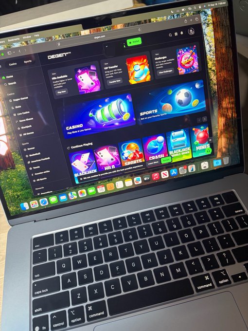 A MacBook laptop open on a wooden surface, displaying the DEGENET sweepstakes/casino website with various games including slots, crash, plinko, and sports betting on the screen.