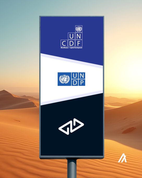 urns of water are visible on a desert landscape, with the UNDP logo and a blue and white banner displaying "UNC" and "CDF".