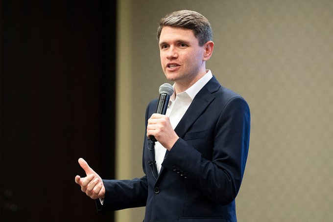 A young man in a dark suit and white shirt speaks into a microphone while gesturing with his free hand, appearing to address an audience at a political or public event.

The image likely depicts James Talarico, the candidate mentioned in the accompanying post who is favored in Kalshi prediction markets against Ken Paxton in the Texas political race.