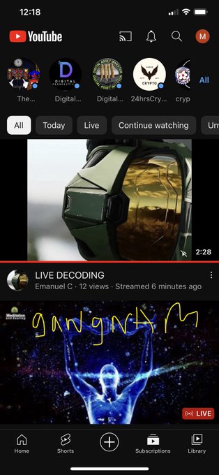 A YouTube mobile app home screen showing live streams and videos, including 'LIVE DECODING' by Emanuel C and a channel showing 'gringing' with a glowing blue figure.