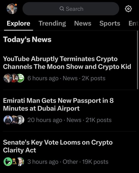 The image shows the X (formerly Twitter) "Explore" tab displaying "Today's News" section, where the top trending story reads "YouTube Abruptly Terminates Crypto Channels The Moon Show and Crypto Kid" (posted 6 hours ago with 2K posts). This relates to the accompanying post, where the user celebrates that news of their channel termination by YouTube has reached the #1 trending spot on X, hoping it will draw YouTube's attention to resolve the issue.