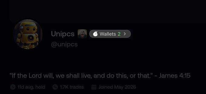 The image shows a profile for "Unipcs" (@unipcs), featuring a bio with the Bible verse "If the Lord will, we shall live, and do this, or that." - James 4:15, along with stats showing 11d avg. hold, 1.7K trades, and a join date of May 2026. The profile displays a "Wallets 2" indicator with an Apple logo, highlighting the new Fomo wallet integration that now allows users to view linked SOL and EVM wallets directly on profiles.