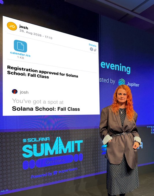 A woman with red hair stands on stage at the Solana Summit Breakpoint event, next to a large screen displaying a registration confirmation email for Solana School: Fall Class.